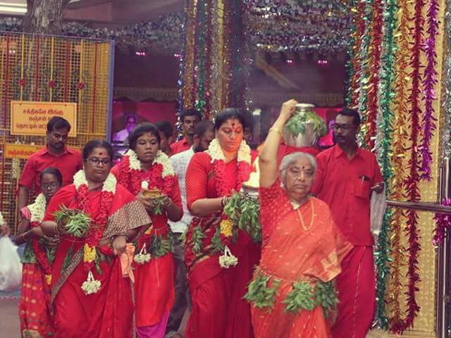 Women carrying pots in procession